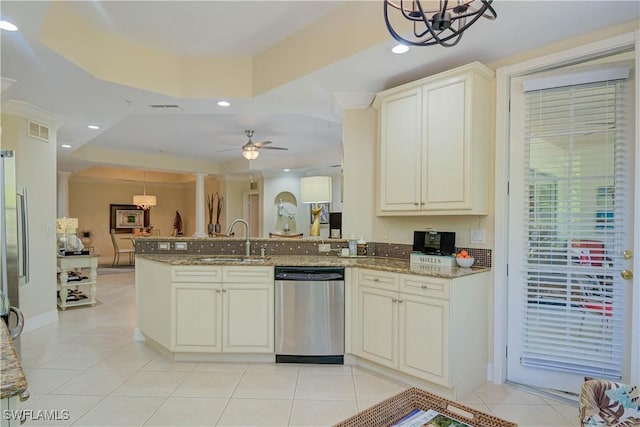 kitchen featuring visible vents, light stone countertops, a peninsula, stainless steel dishwasher, and a sink