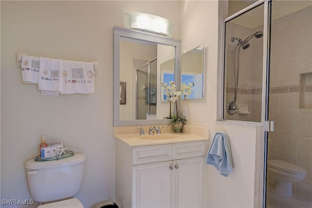 full bathroom with a shower stall, toilet, and vanity