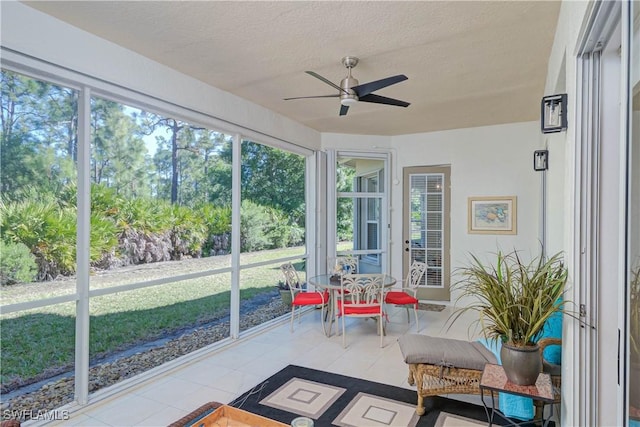 sunroom featuring a ceiling fan