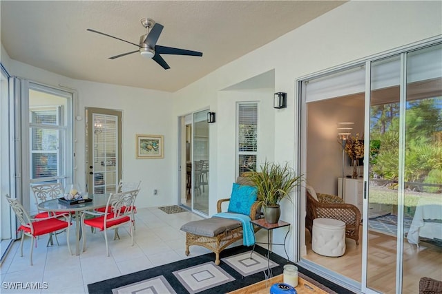 interior space with ceiling fan