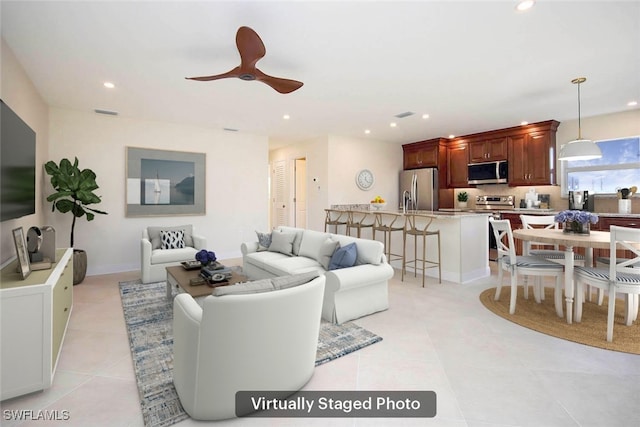 living room with light tile patterned floors and ceiling fan