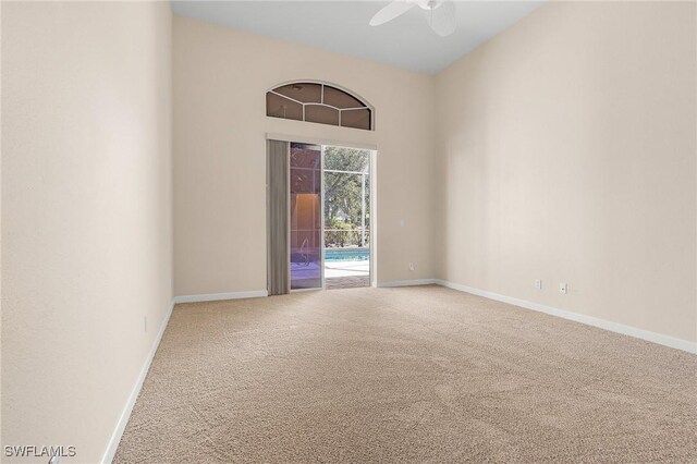 empty room featuring ceiling fan and carpet