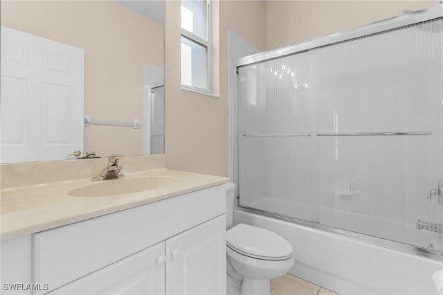 full bathroom with enclosed tub / shower combo, vanity, toilet, and tile patterned flooring