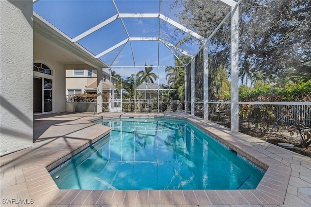 view of swimming pool with a patio and a lanai