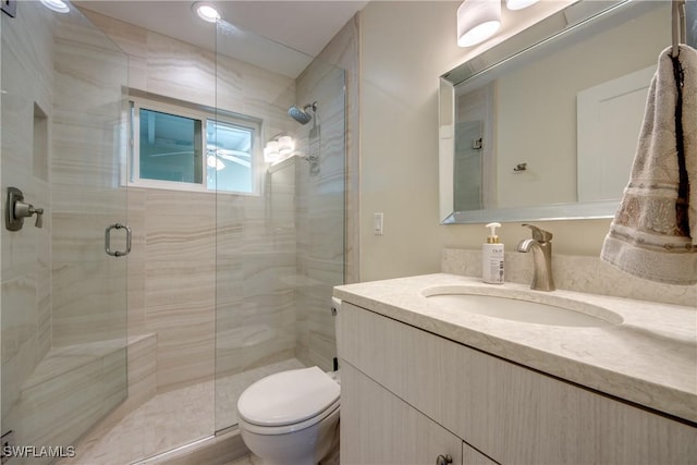 bathroom with vanity, toilet, and walk in shower