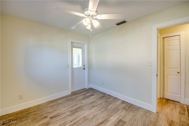 spare room with ceiling fan and light wood-type flooring