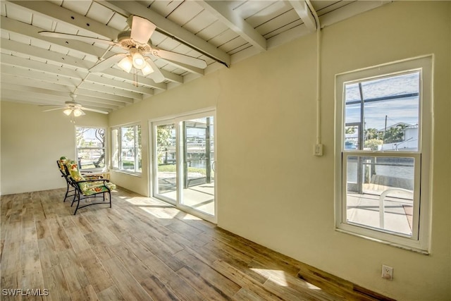 unfurnished sunroom with beamed ceiling, ceiling fan, and wood ceiling