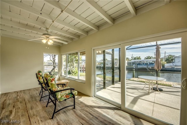 sunroom / solarium featuring beamed ceiling, a water view, a healthy amount of sunlight, and wooden ceiling