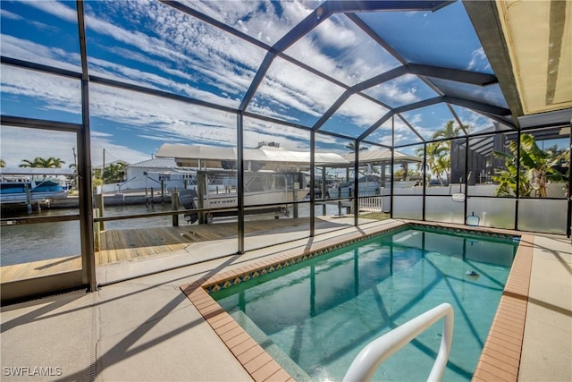 view of pool with a lanai, a patio, and a dock