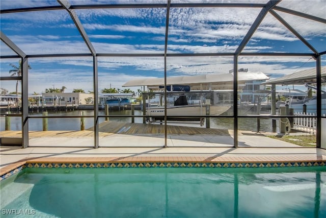 view of swimming pool with a water view and a lanai