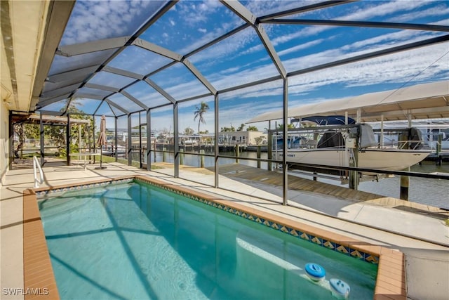 view of pool with a water view, a patio, a dock, and glass enclosure