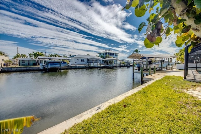 dock area with a water view and a yard