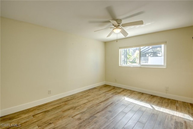 empty room with ceiling fan and light hardwood / wood-style floors