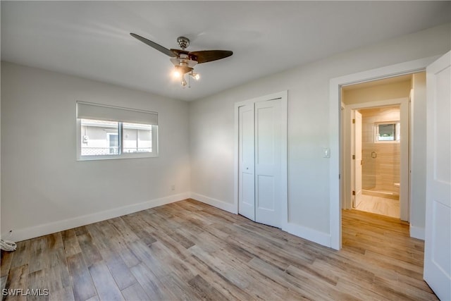 unfurnished bedroom featuring light hardwood / wood-style flooring, a closet, and ceiling fan