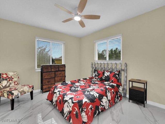 bedroom featuring multiple windows and ceiling fan