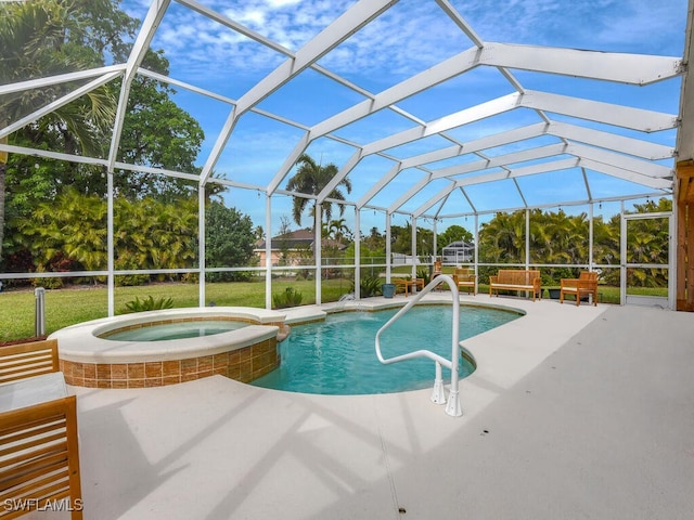 view of swimming pool featuring an in ground hot tub, a lanai, and a patio