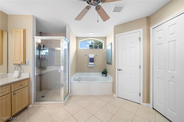 bathroom with shower with separate bathtub, ceiling fan, vanity, and tile patterned floors