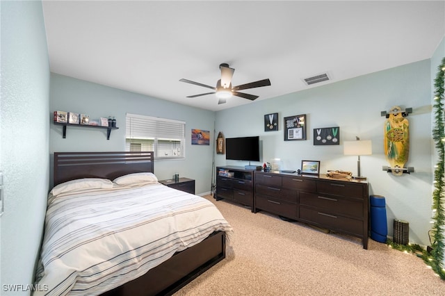 bedroom with light colored carpet and ceiling fan