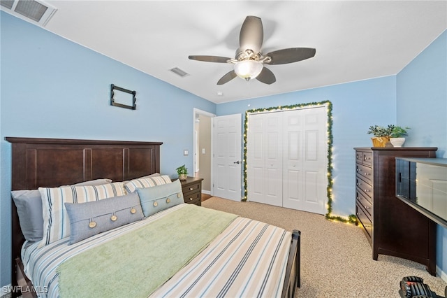 bedroom with light carpet, a closet, and ceiling fan