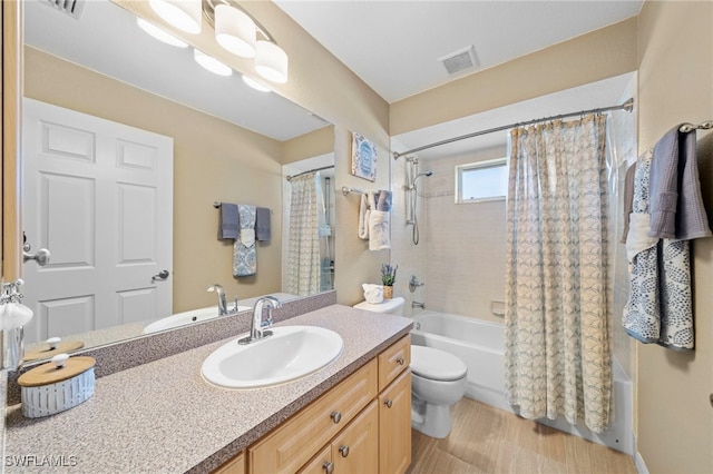 full bathroom featuring shower / tub combo with curtain, vanity, and toilet