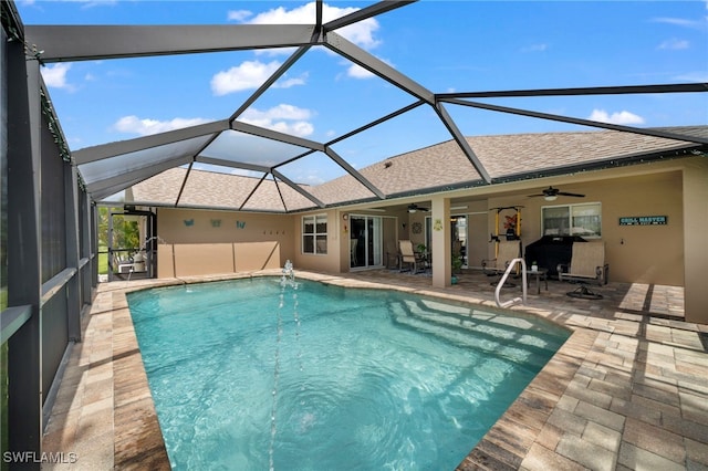 view of swimming pool featuring a patio, a lanai, and ceiling fan