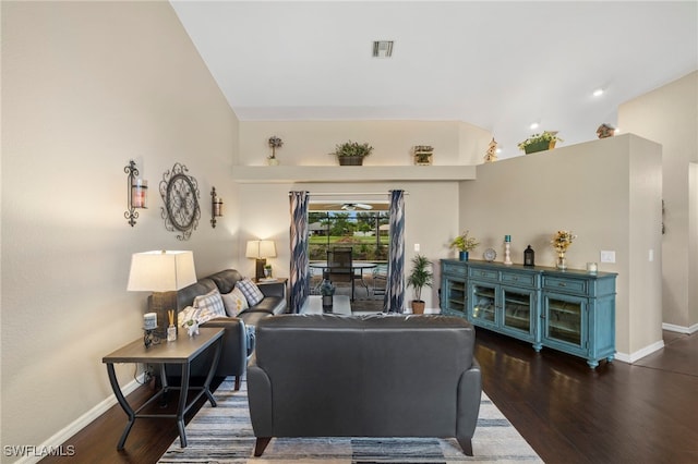 living room featuring lofted ceiling and dark hardwood / wood-style floors