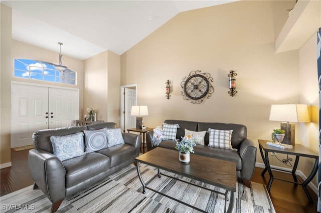 living room featuring lofted ceiling and hardwood / wood-style flooring