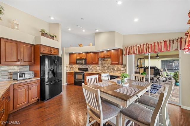 dining area with dark hardwood / wood-style flooring and high vaulted ceiling