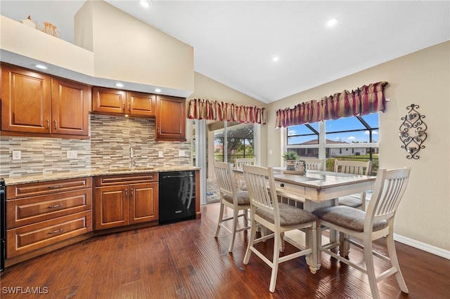 kitchen featuring sink, dark wood-type flooring, dishwasher, light stone countertops, and decorative backsplash