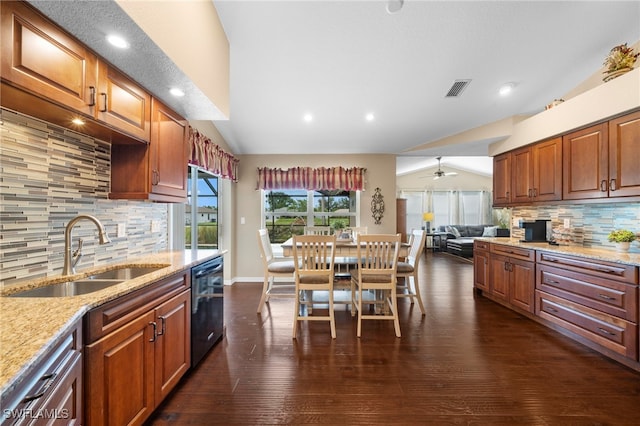 kitchen with lofted ceiling, sink, tasteful backsplash, and black dishwasher