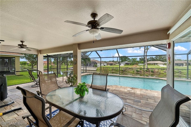 sunroom with a pool and ceiling fan