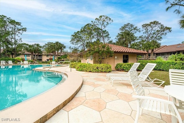 3219 Horse Carriage Way Unit 306, Naples, FL 34105 - community pool with a patio area