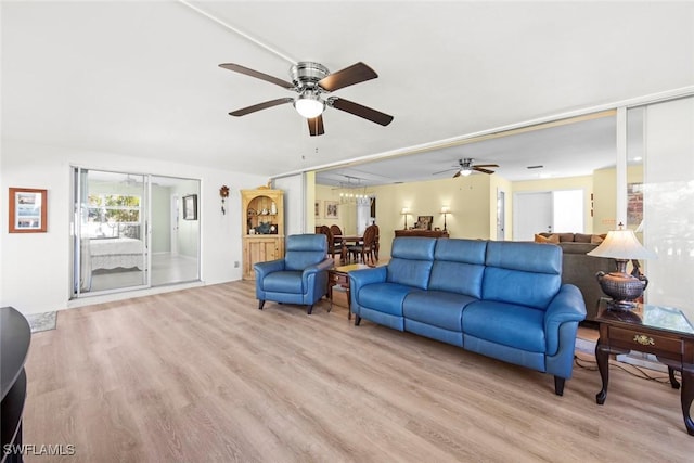 living room with ceiling fan and light hardwood / wood-style floors