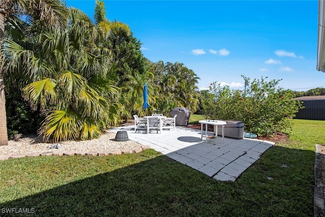 view of yard with a hot tub and a patio