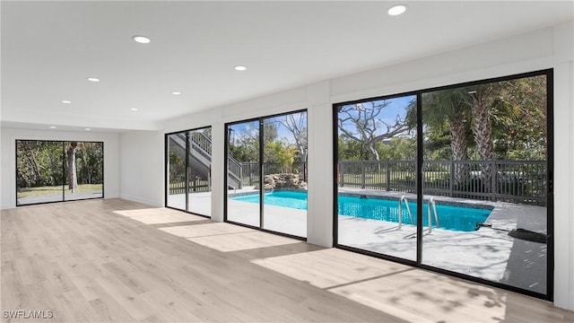 doorway to outside with a healthy amount of sunlight and light hardwood / wood-style flooring