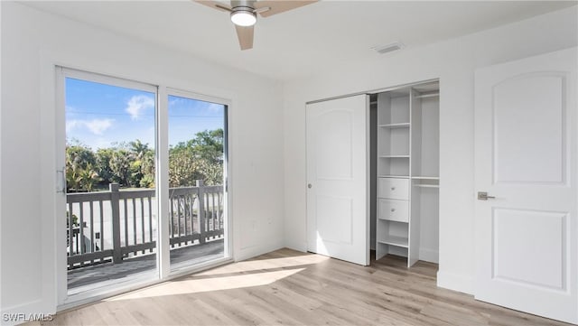 unfurnished bedroom with ceiling fan, access to exterior, a closet, and light wood-type flooring