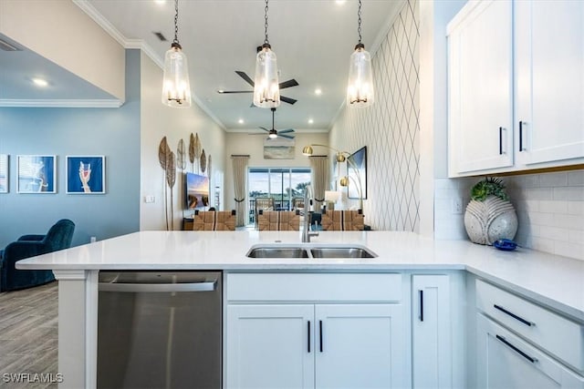 kitchen featuring stainless steel dishwasher, white cabinets, and kitchen peninsula