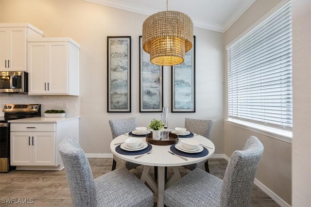 dining space featuring crown molding and an inviting chandelier