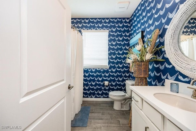 bathroom featuring vanity and toilet