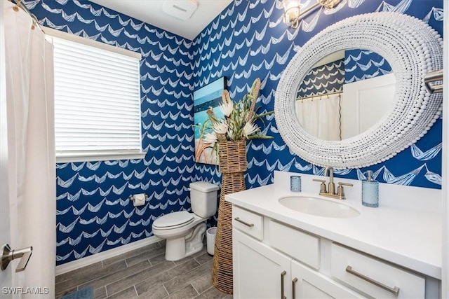 bathroom featuring vanity and toilet