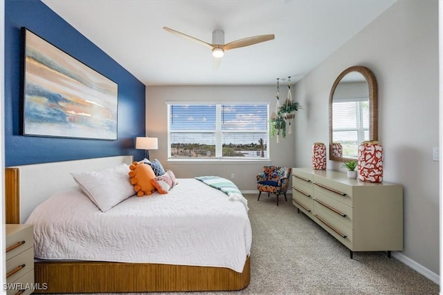 bedroom with ceiling fan and light colored carpet