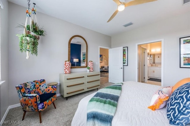 carpeted bedroom featuring ceiling fan and ensuite bath