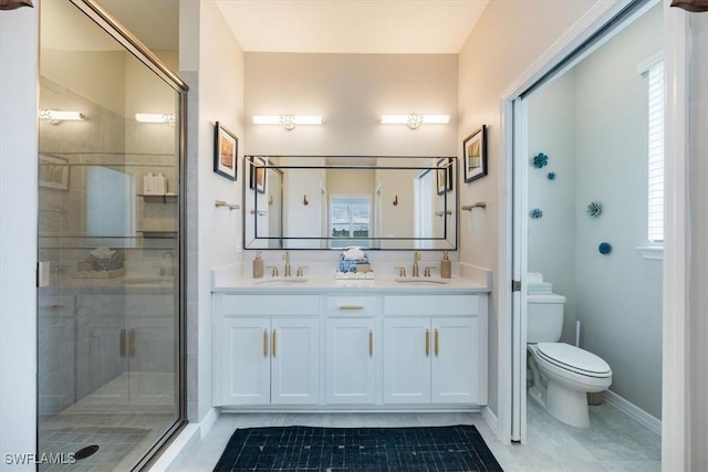 bathroom with vanity, toilet, and an enclosed shower