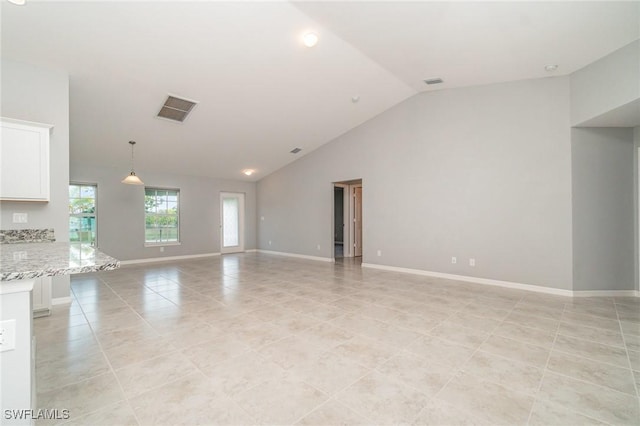 unfurnished living room featuring light tile patterned floors, high vaulted ceiling, visible vents, and baseboards