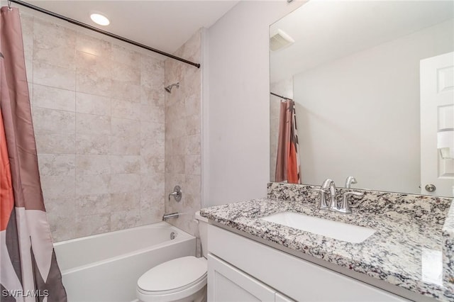 bathroom featuring toilet, vanity, shower / bath combination with curtain, and visible vents