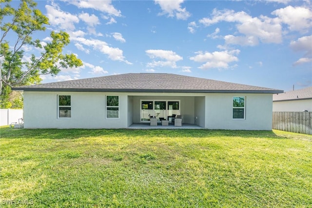 back of property with a yard, stucco siding, outdoor lounge area, a patio area, and fence private yard