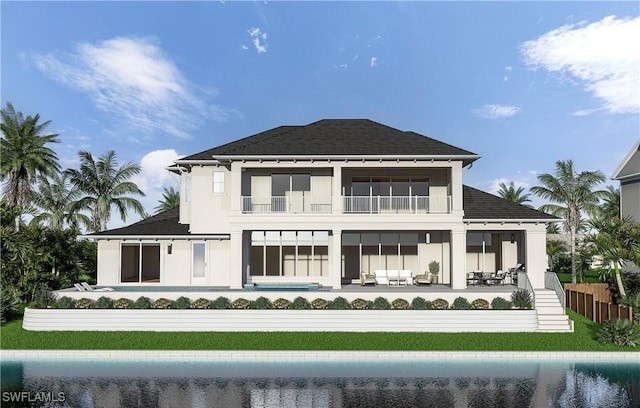 rear view of house with a patio area, outdoor lounge area, a balcony, and a lawn