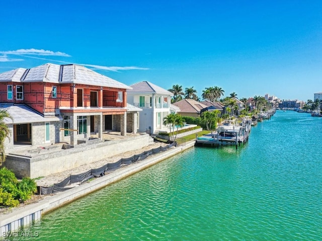 rear view of house with a balcony and a water view