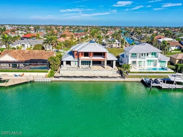 birds eye view of property with a water view