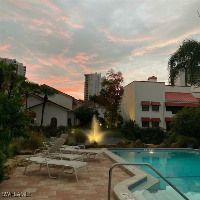 view of pool at dusk